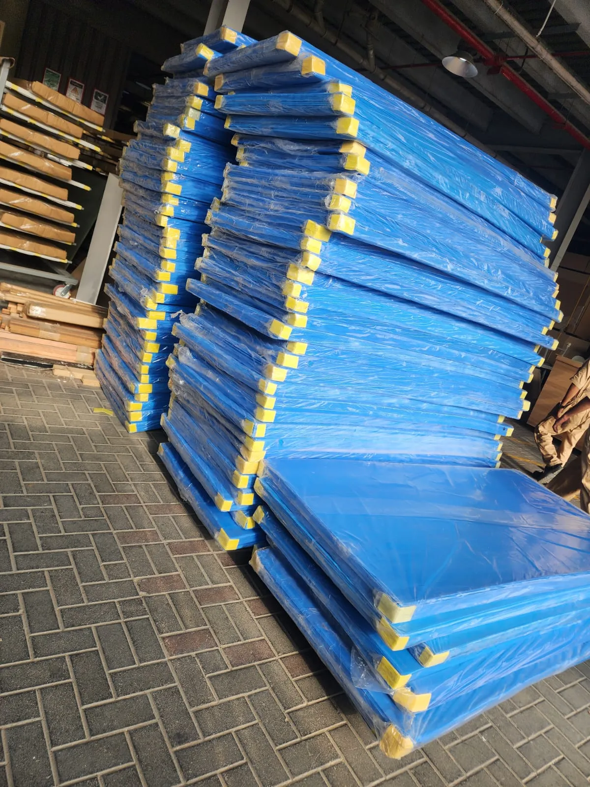 Bed mattresses stacked on pickup truck for apartment delivery in Dubai